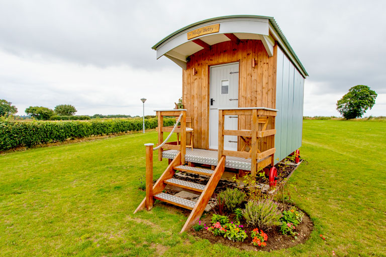 Our huts are in a secluded paddock surrounded on three sides by fields as far as the eye can see