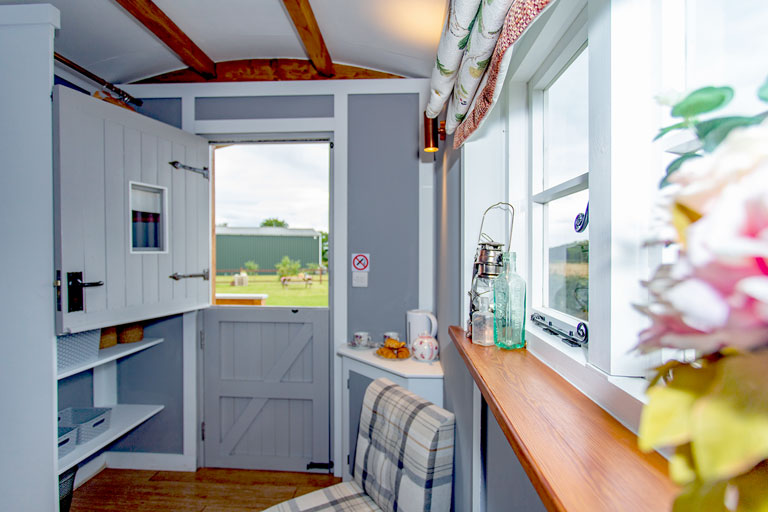 Looking back towards the door of Hedge Betty, with the green barns beyond